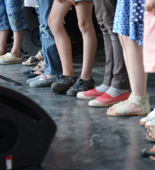 photo de pieds d'enfants sur scène illustrant l'article sur le CLEA de Lons-le-Saunier